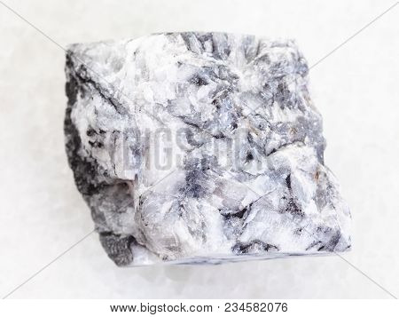 Macro Shooting Of Natural Mineral Rock Specimen - Raw Magnesite Stone On White Marble Background Fro