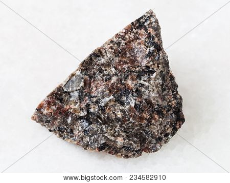 Macro Shooting Of Natural Mineral Rock Specimen - Raw Spreusteined Urtite Stone On White Marble Back