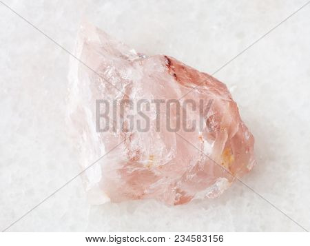 Macro Shooting Of Natural Mineral Rock Specimen - Raw Crystal Of Rose Quartz Gemstone On White Marbl