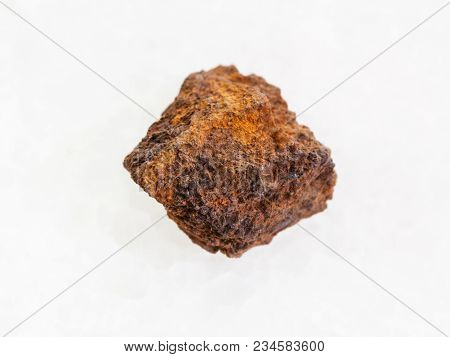 Macro Shooting Of Natural Mineral Rock Specimen - Raw Limonite (iron Ore) Stone On White Marble Back
