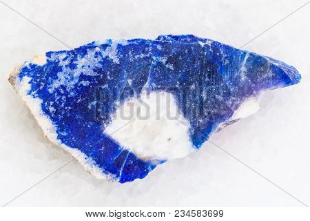 Macro Shooting Of Natural Mineral Rock Specimen - Raw Lazurite (lapis Lazuli) Stone On White Marble 