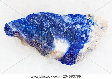 Macro Shooting Of Natural Mineral Rock Specimen - Rough Lazurite (lapis Lazuli) Stone On White Marbl