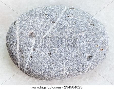 Macro Shooting Of Natural Mineral Rock Specimen - Tumbled Grauwacke Sandstone On White Marble Backgr