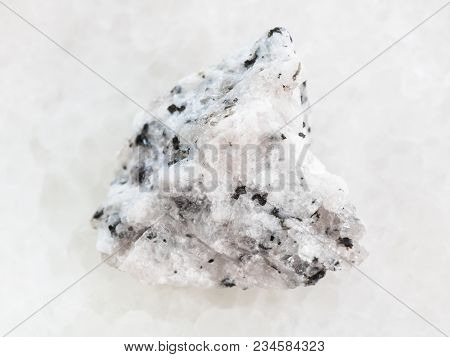 Macro Shooting Of Natural Mineral Rock Specimen - Raw Diorite Stone On White Marble Background