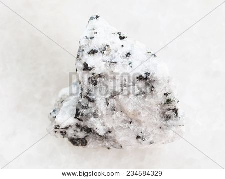 Macro Shooting Of Natural Mineral Rock Specimen - Rough Diorite Stone On White Marble Background