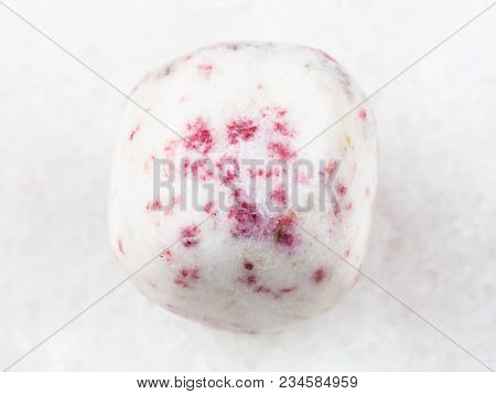 Macro Shooting Of Natural Mineral Rock Specimen - Cinnabar In Tumbled White Dolomite Stone On White 