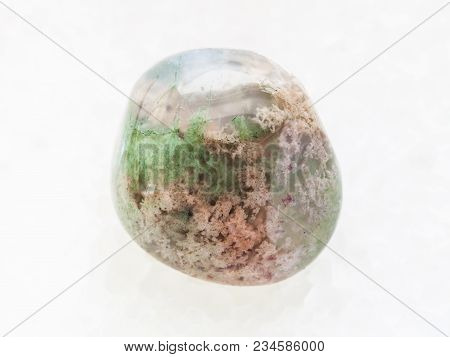 Macro Shooting Of Natural Mineral Rock Specimen - Polished Moss Agate Gemstone On White Marble Backg