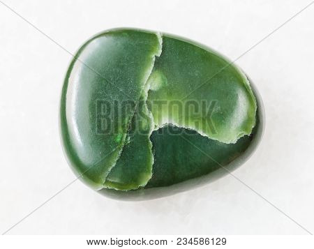 Macro Shooting Of Natural Mineral Rock Specimen - Polished Green Nephrite Gemstone On White Marble B