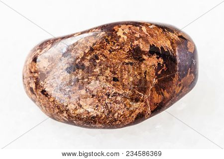 Macro Shooting Of Natural Mineral Rock Specimen - Polished Bronzite Gemstone On White Marble Backgro