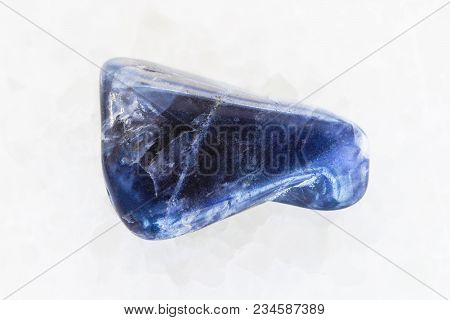 Macro Shooting Of Natural Mineral Rock Specimen - Polished Dumortierite Gemstone On White Marble Bac