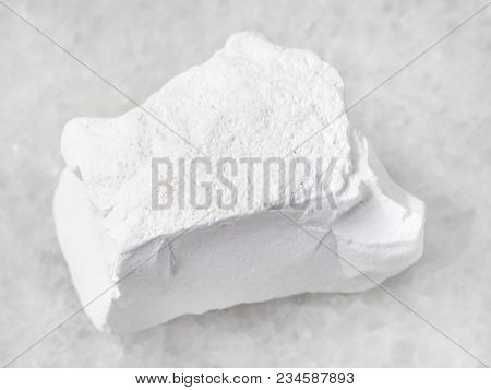 Macro Shooting Of Natural Mineral Rock Specimen - Rough Chalk Stone On White Marble Background