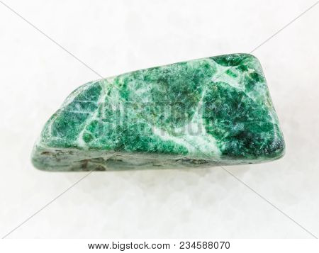 Macro Shooting Of Natural Mineral Rock Specimen - Polished Green Jadeite Stone On White Marble Backg