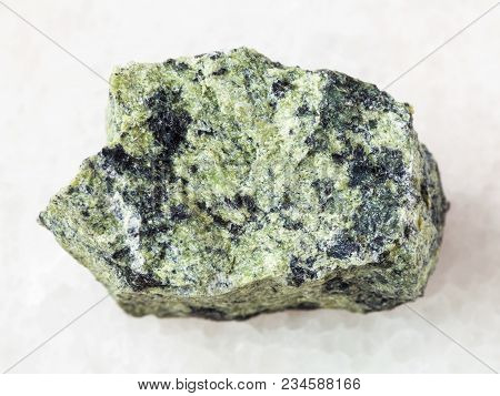Macro Shooting Of Natural Mineral Rock Specimen - Raw Serpentinite Stone On White Marble Background