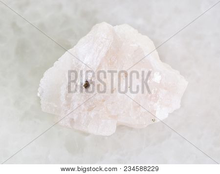 Macro Shooting Of Natural Mineral Rock Specimen - Raw Barite Stone On White Marble Background
