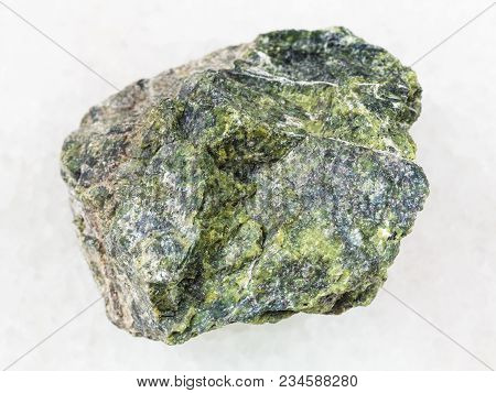 Macro Shooting Of Natural Mineral Rock Specimen - Raw Serpentine Stone On White Marble Background