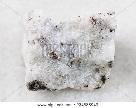Macro Shooting Of Natural Mineral Rock Specimen - Rough Carbonatite Stone On White Marble Background