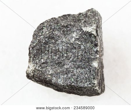 Macro Shooting Of Natural Mineral Rock Specimen - Raw Gabbro Stone On White Marble Background