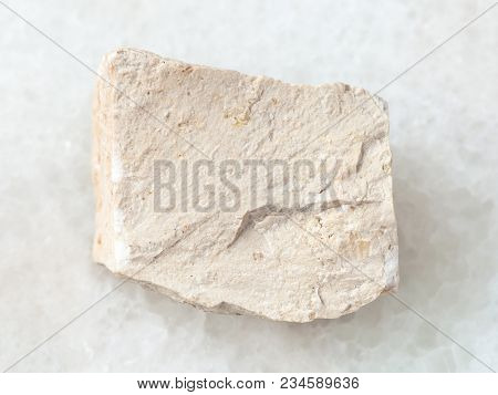 Macro Shooting Of Natural Mineral Rock Specimen - Raw Chemical Limestone Stone On White Marble Backg