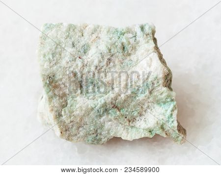 Macro Shooting Of Natural Mineral Rock Specimen - Rough Listwanite Stone On White Marble Background