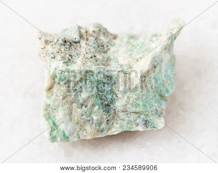 Macro Shooting Of Natural Mineral Rock Specimen - Piece Of Rough Listwanite Stone On White Marble Ba