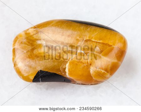 Macro Shooting Of Natural Mineral Rock Specimen - Tumbled Simbircite Gemstone On White Marble Backgr
