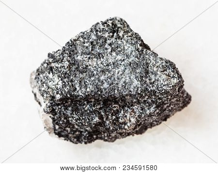 Macro Shooting Of Natural Mineral Rock Specimen - Rough Amphibolite Stone On White Marble Background