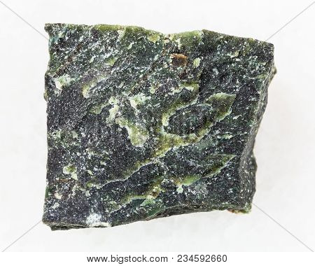 Macro Shooting Of Natural Mineral Rock Specimen - Raw Dunite Stone On White Marble Background