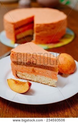 Pie With Peach Souffle. A Piece Of Peach Pie With A Souffle On A Plate.