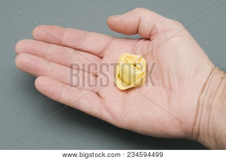 A Single Tortellino Pasta On The Hand