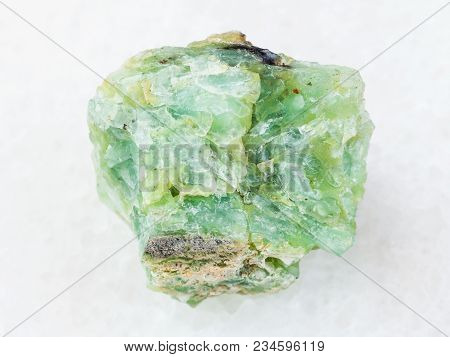 Macro Shooting Of Natural Mineral Rock Specimen - Rough Crystal Of Chrysopal Gemstone On White Marbl