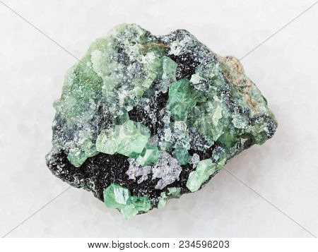 Macro Shooting Of Natural Mineral Rock Specimen - Raw Crystals Of Demantoid Garnet Stone On White Ma