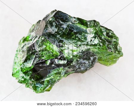 Macro Shooting Of Natural Mineral Rock Specimen - Green Crystal Of Chrome Diopside Gemstone On White
