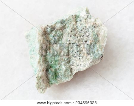Macro Shooting Of Natural Mineral Rock Specimen - Raw Listwanite Stone On White Marble Background