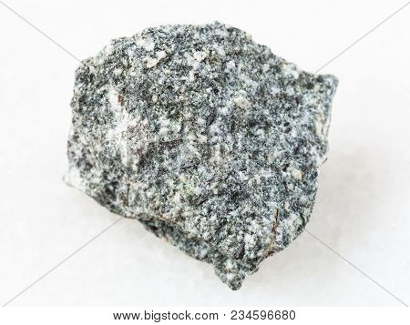 Macro Shooting Of Natural Mineral Rock Specimen - Rough Diorite Stone On White Marble Background