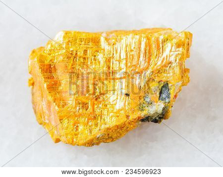 Macro Shooting Of Natural Mineral Rock Specimen - Rough Native Orpiment Stone On White Marble Backgr