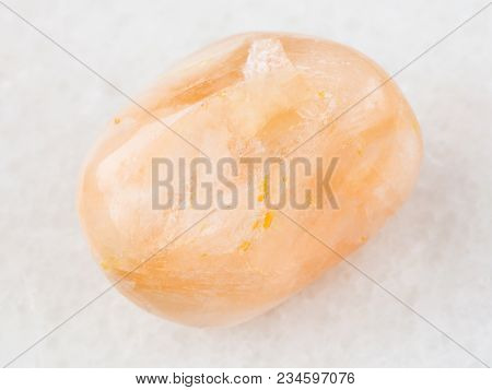 Macro Shooting Of Natural Mineral Rock Specimen - Tumbled Stilbite Gemstone On White Marble Backgrou