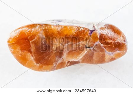 Macro Shooting Of Natural Mineral Rock Specimen - Tinaksite Gemstone On White Marble Background From