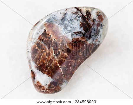 Macro Shooting Of Natural Mineral Rock Specimen - Polished Eudialyte In Syenite Stone On White Marbl