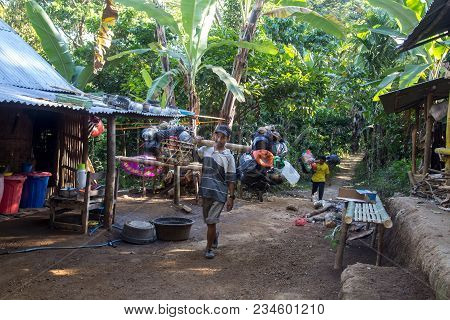 Lombok, Indonesia - July 14, 2015: Two Porters Carrying Goods On The Way Up To Mount Rinjani