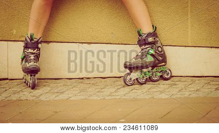 Woman Wearing Roller Skates In Town. Female Being Sporty During Summer Time.
