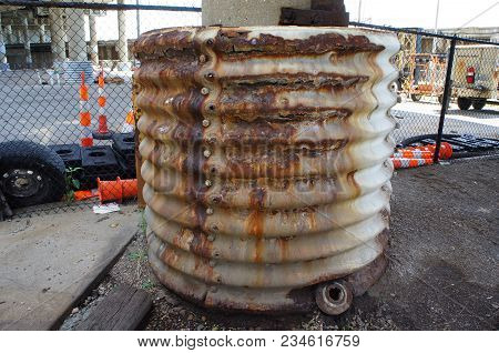 Construction Site With Orange Traffic Cones And Rusted Pillar
