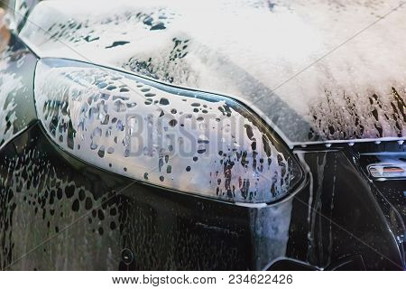 Car Covered With Foam On Car Wash