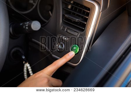 Close-up Portrait Of Woman Finger Pressing Switch On/off Of Eco Mode In The Car.