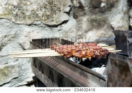 Arrosticini On The Grill, Abruzzi Skewers Of Sheep Cooked On The Grate And On A Special Brazier.