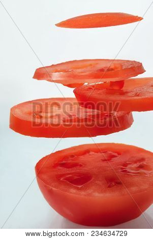 Fresh Natural Juicy Red Tomato Sliced In Air Close-up.