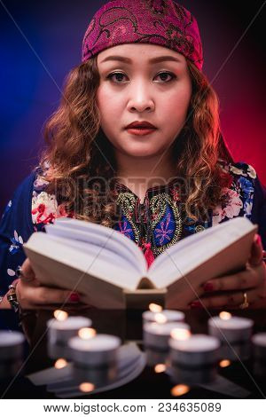 Female Seer Teller Doing Psychic Reading Book