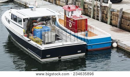 A Real Boat That Looks Like A Toy Tug Boat Is Tied To A Dock And Another Boat In Rockland Maine