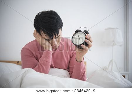 Man Wake Up Doing Turn Off Alarm Clock In The Morning. He Tired And Lazy Do Work.