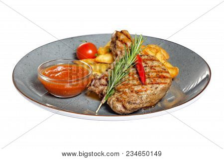 Fried Meat With Garnish Of Pepper, Zucchini, Tomato And Corn With Ajika Sauce Served On A Gray Plate