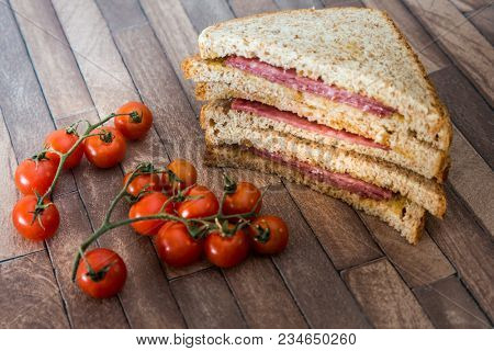 Wholemeal bread sandwich topped with Lyon rosette and butter